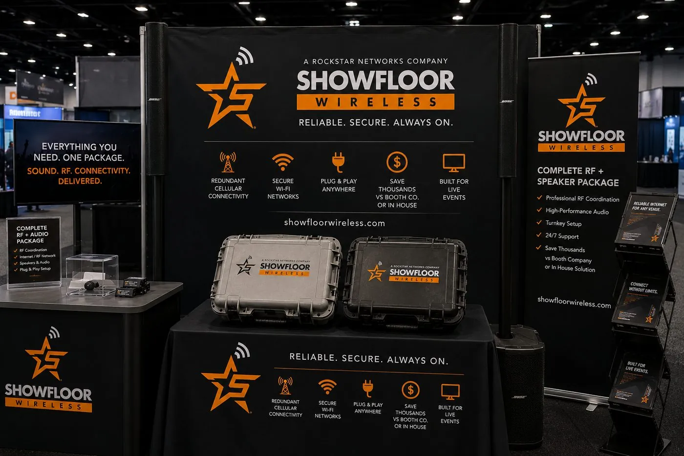 A trade show booth with two Bose speaker towers flanking the back wall